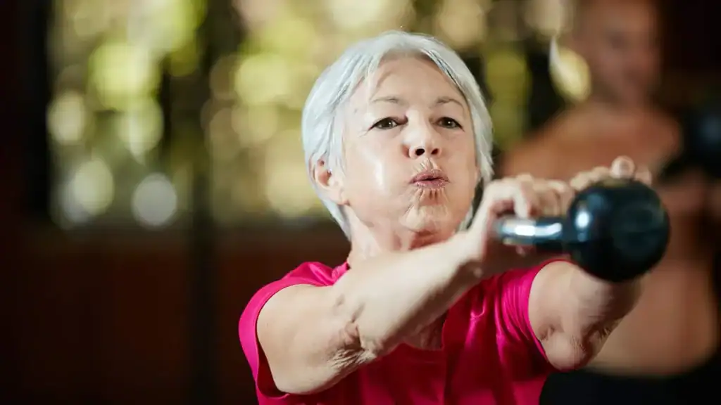Toning Arms After 60: Empowering Womens Fitness Through Effective Weight Training 1 Older woman doing weight training Wealdstone to help her strength and longevity